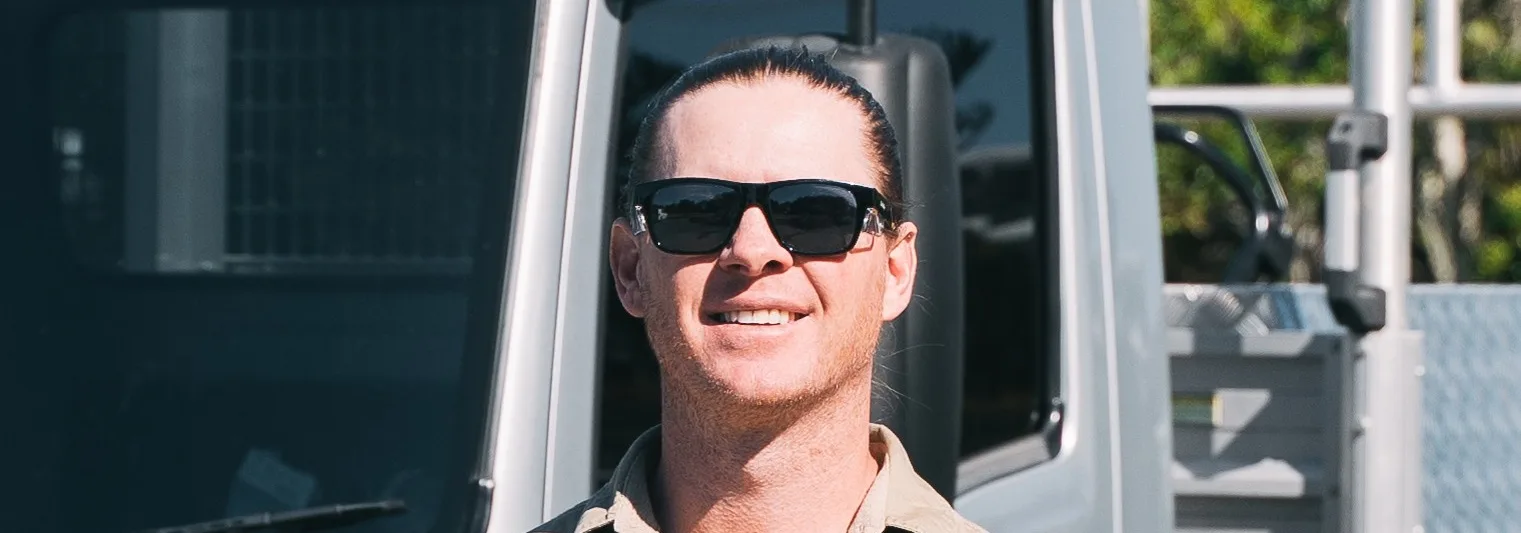 HWD Landscape and Maintenance team member beside the service truck, Gold Coast